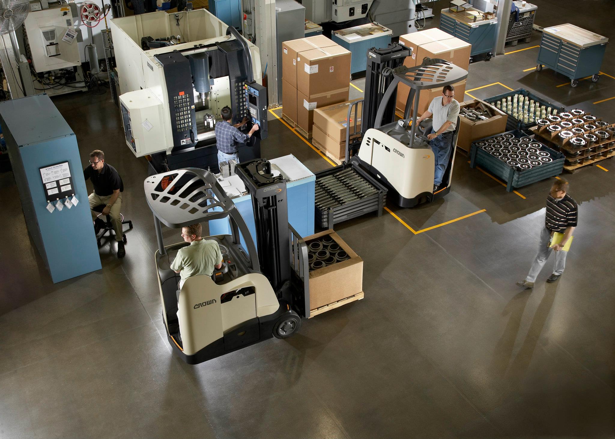 Birdseye view of 5 employees working in a Massachusetts warehouse facility. Tracking orders, operating equipment including Crown forklifts.