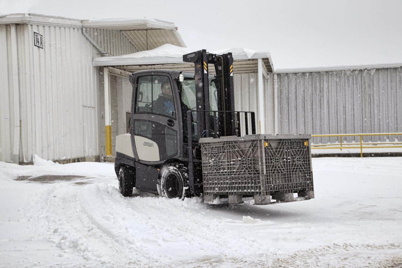 Worker practing proper fall protection, attaching lanyard to person fall protection equipment