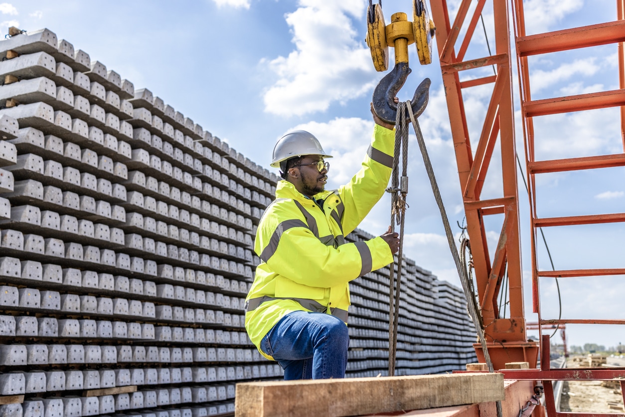 Birdseye view of 5 employees working in a Massachusetts warehouse facility. Tracking orders, operating equipment including Crown forklifts.