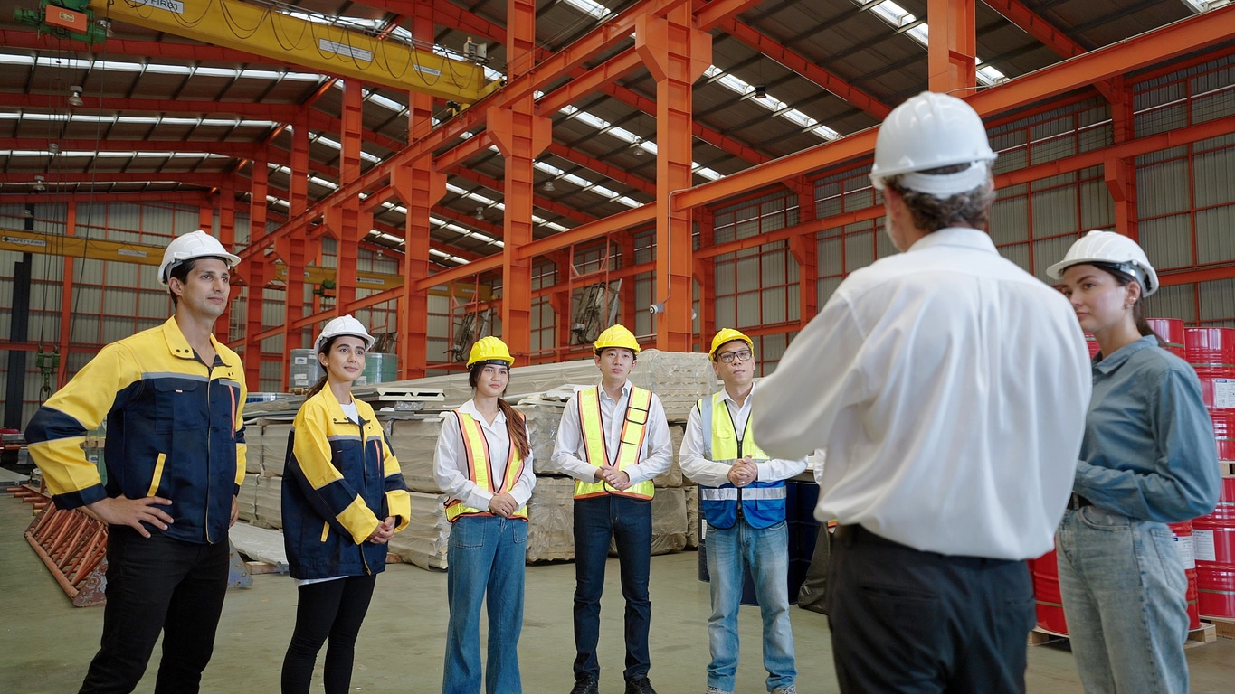 Skyjack equipment example showing employee on heightened scissor lift leaning over to drill something