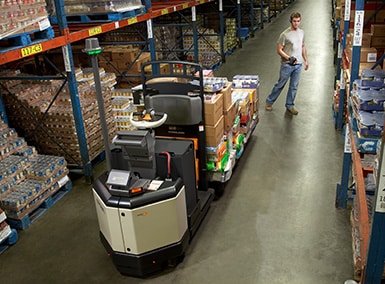 Skyjack equipment example showing employee on heightened scissor lift leaning over to drill something